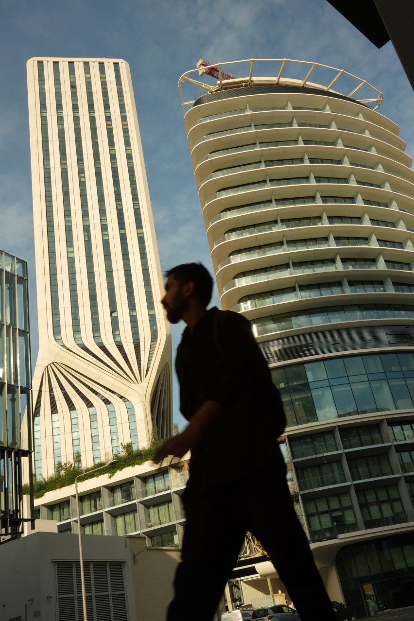 Man walking past Mercury Tower