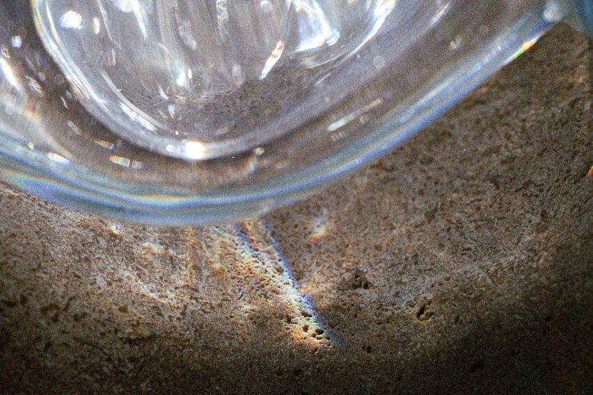 Close-up photo of reflections on a stone surface from a bubble-like glass block