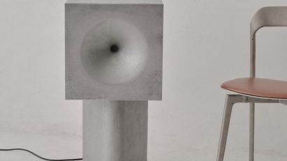 Cast speaker beside chair