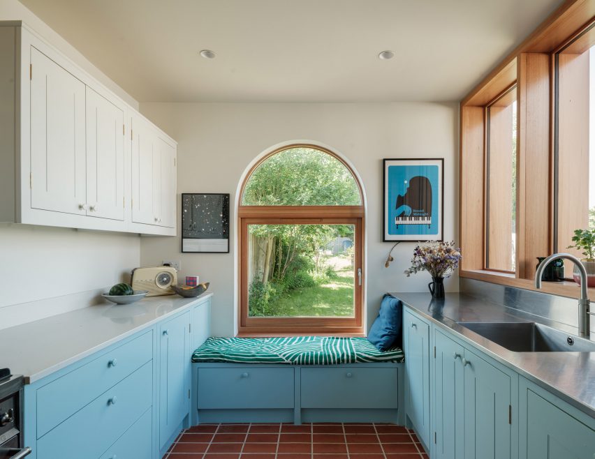 Tiled floor and blue wood panelling in kitchen extension