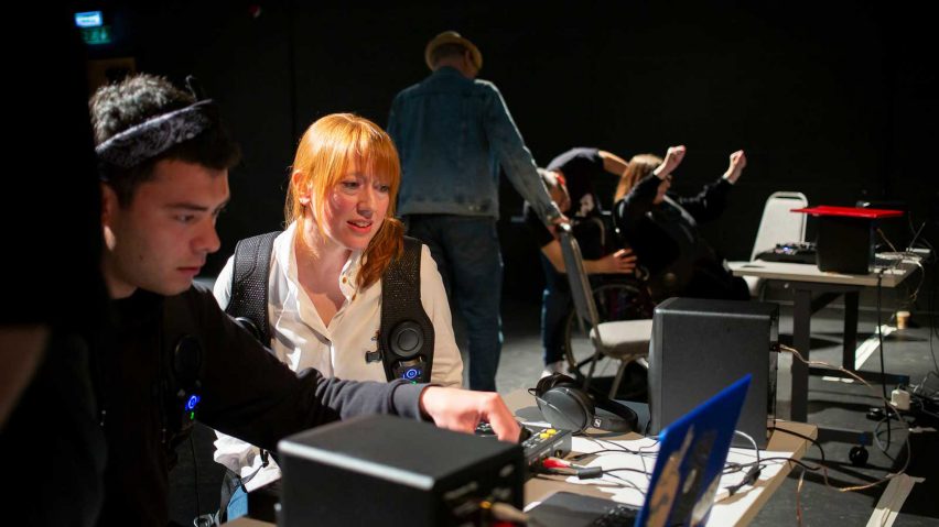 A photograph of two people looking at a computer.