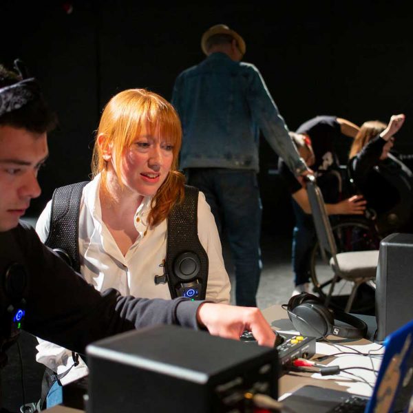 A photograph of two people looking at a computer.