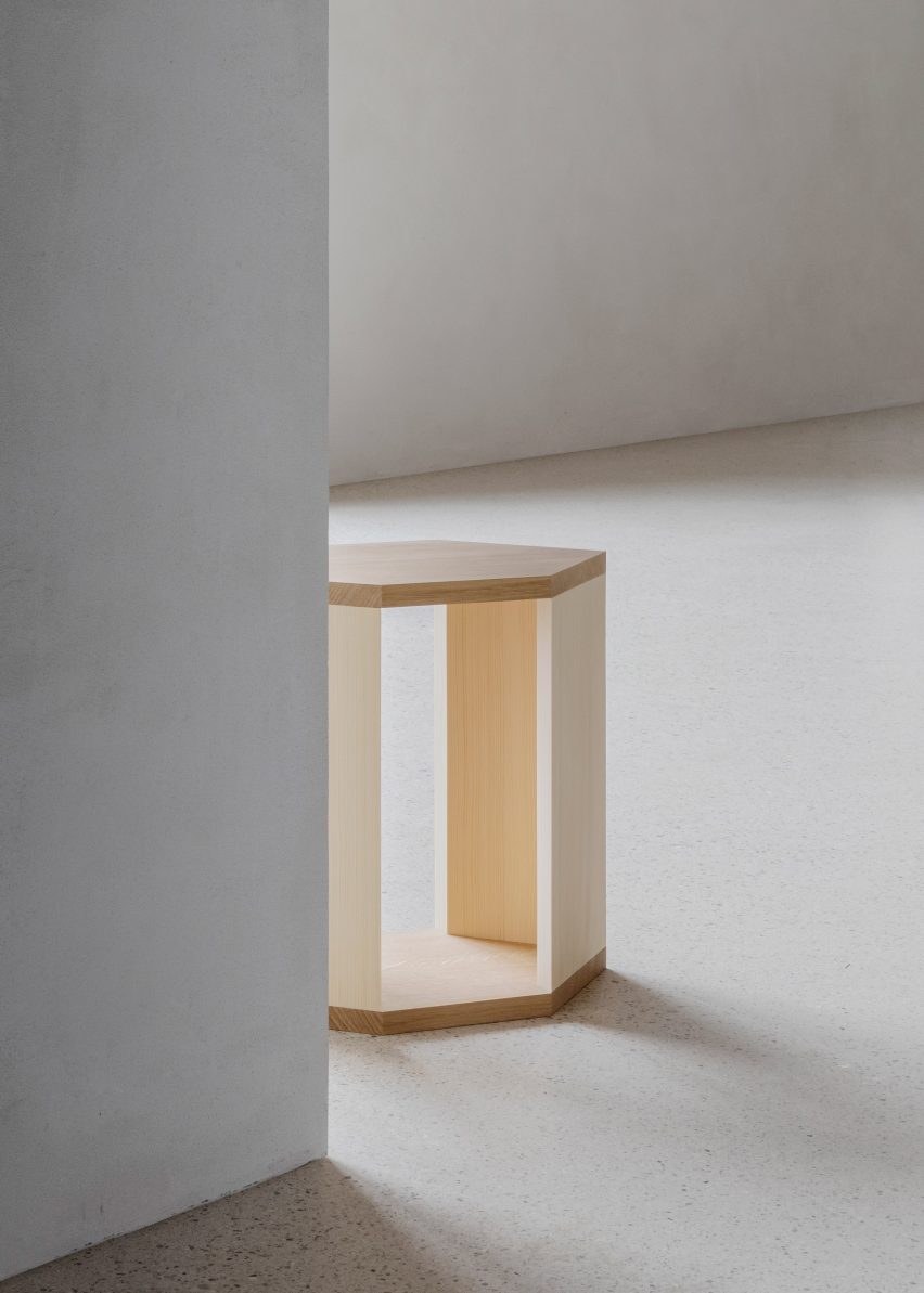 Wooden side table in white-walled interior