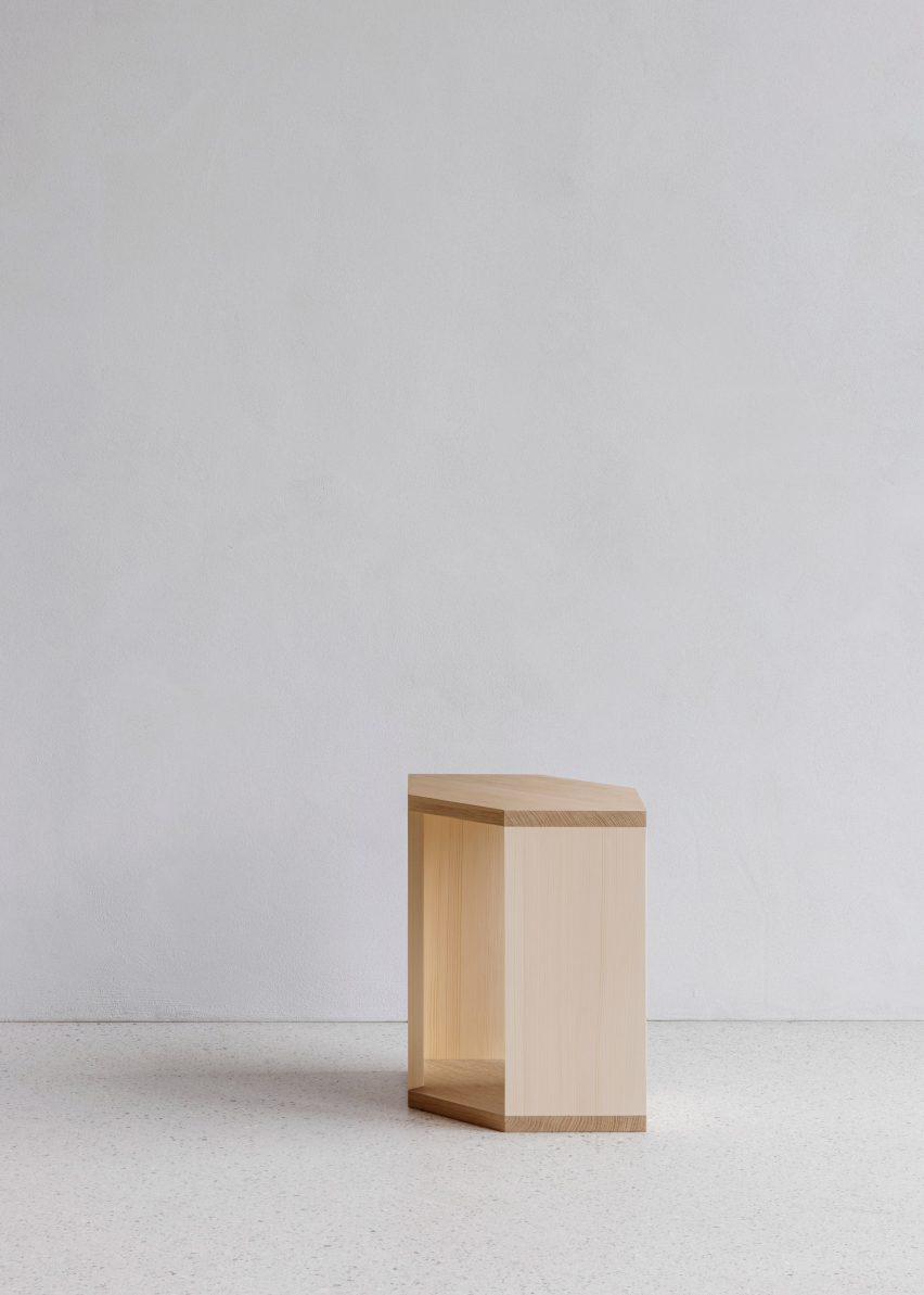 Wooden side table in white-walled interior