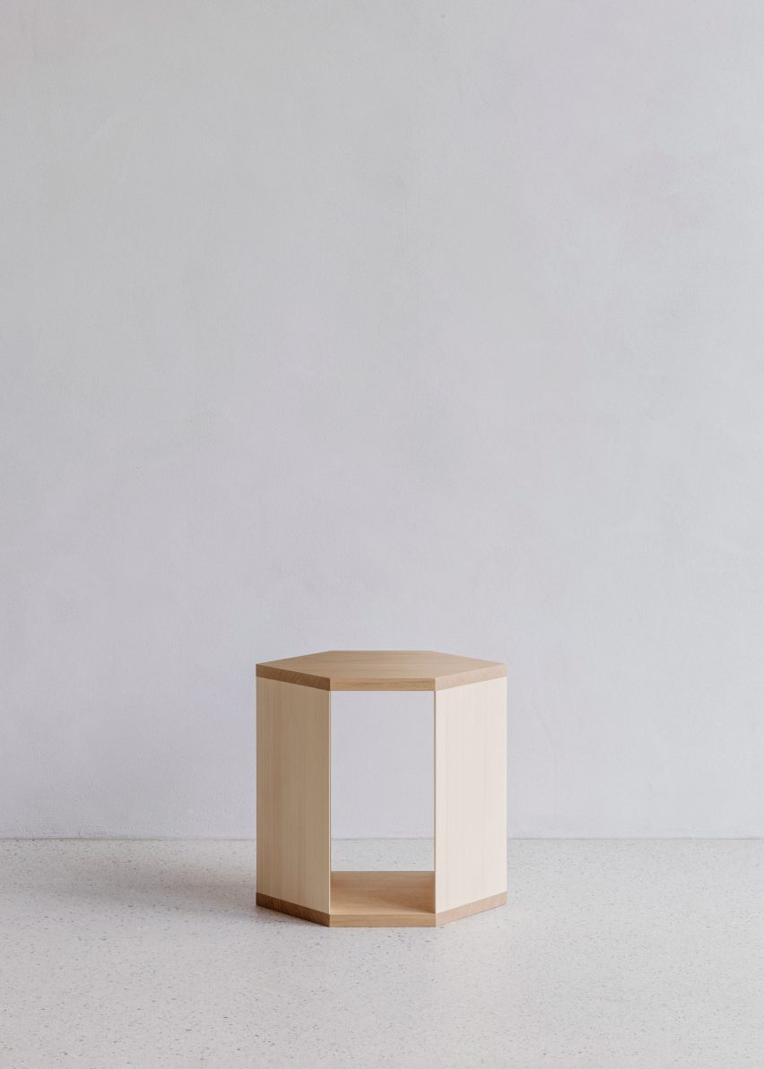 Wooden side table in white-walled interior