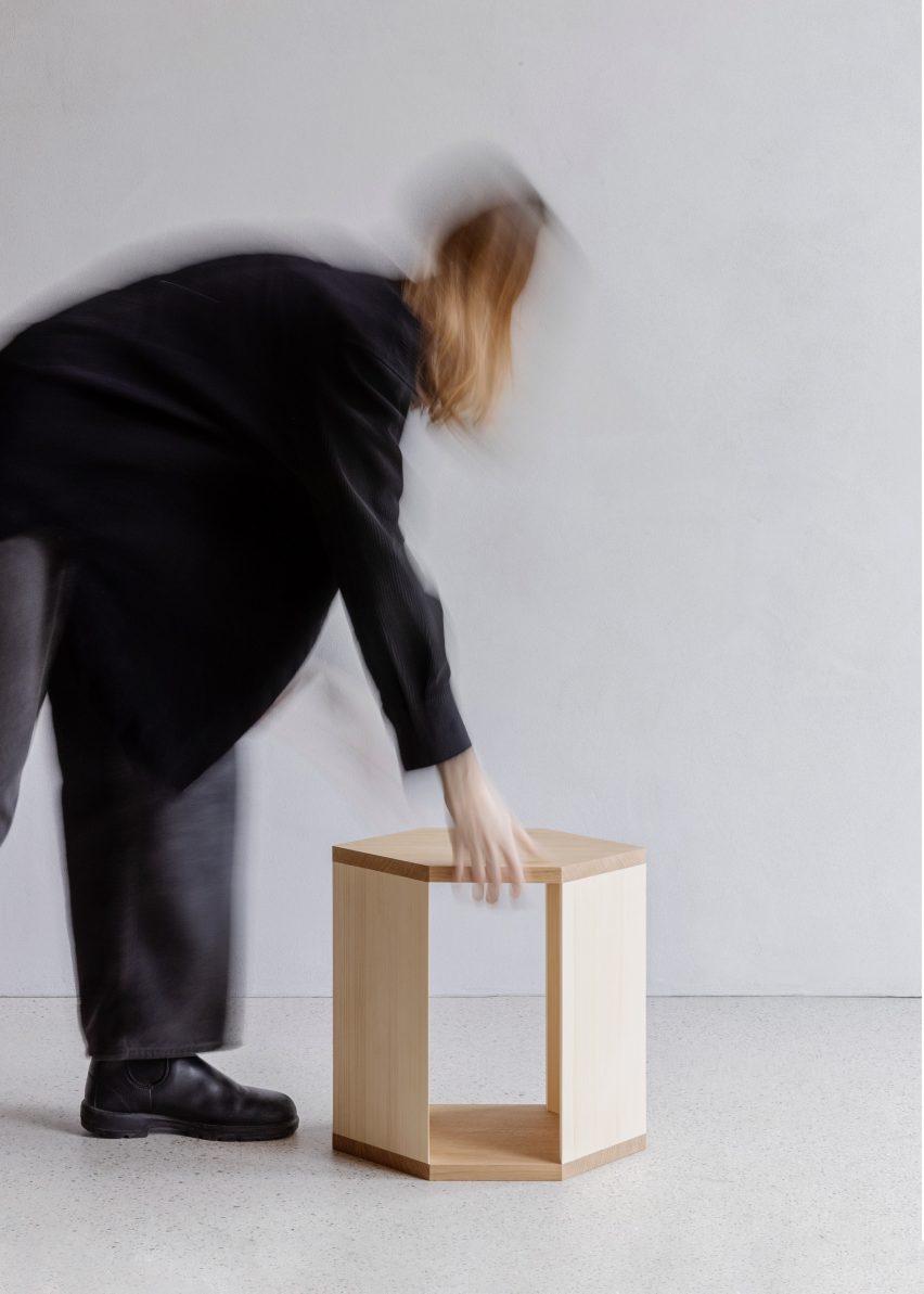 Person picking up wooden side table