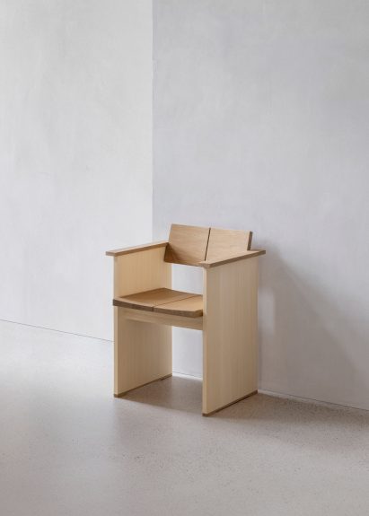Wooden chair against white wall