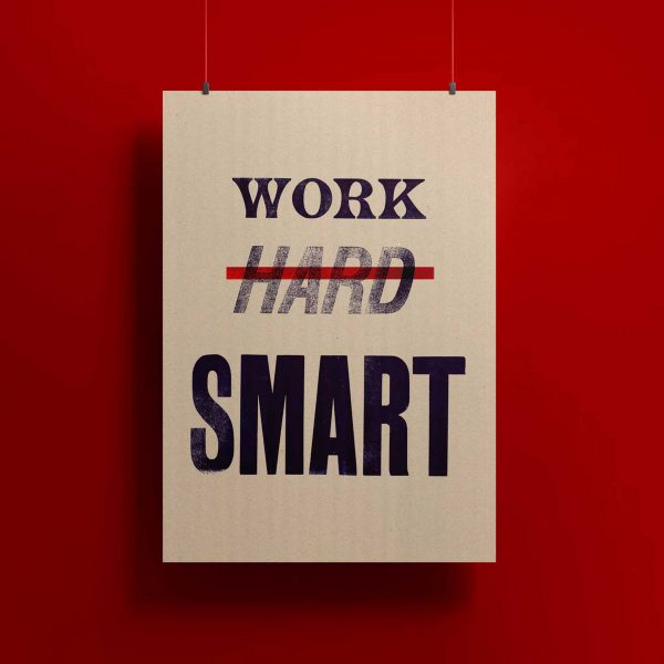 A photograph of a poster in tones of white against a red background, with the words 'work', 'hard' and 'smart' written on it in black text.