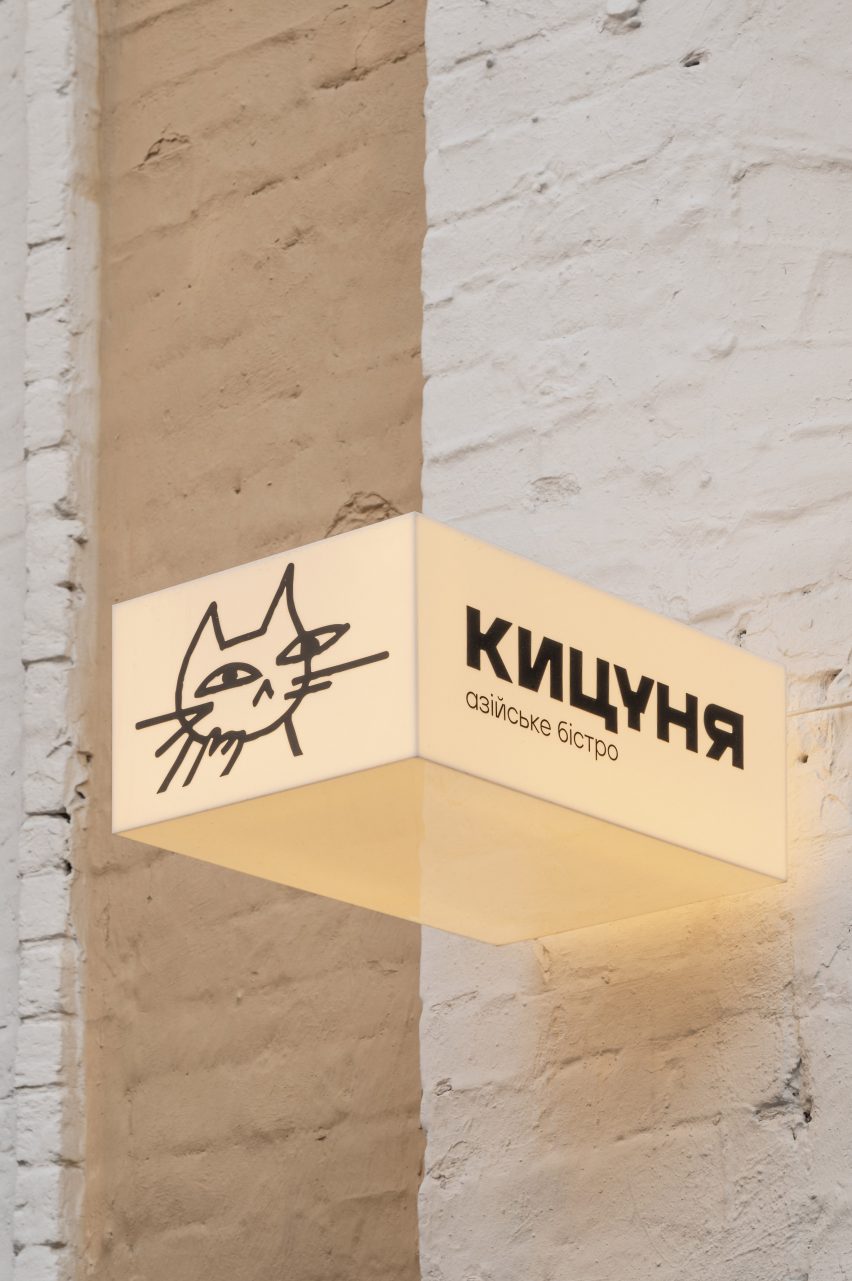 Signage for bistro featuring a cats face