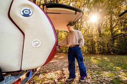 Man opening 3D-printed Tiny Camper by Lemki Robotix