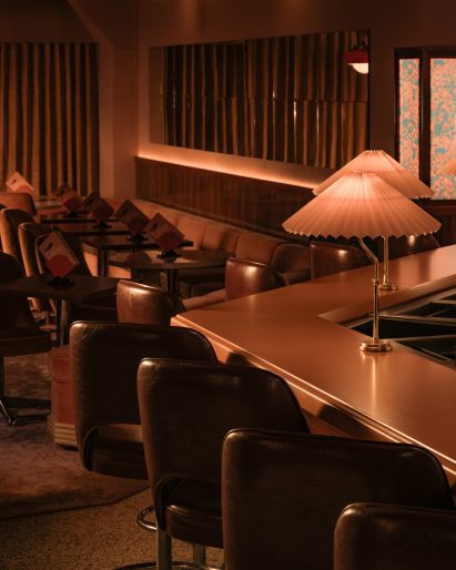 Restaurant with dim bar top lamps and cove lighting
