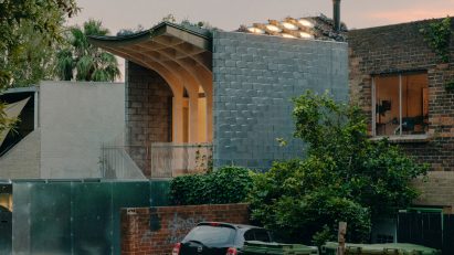 Melnourne house with curved roof at dusk