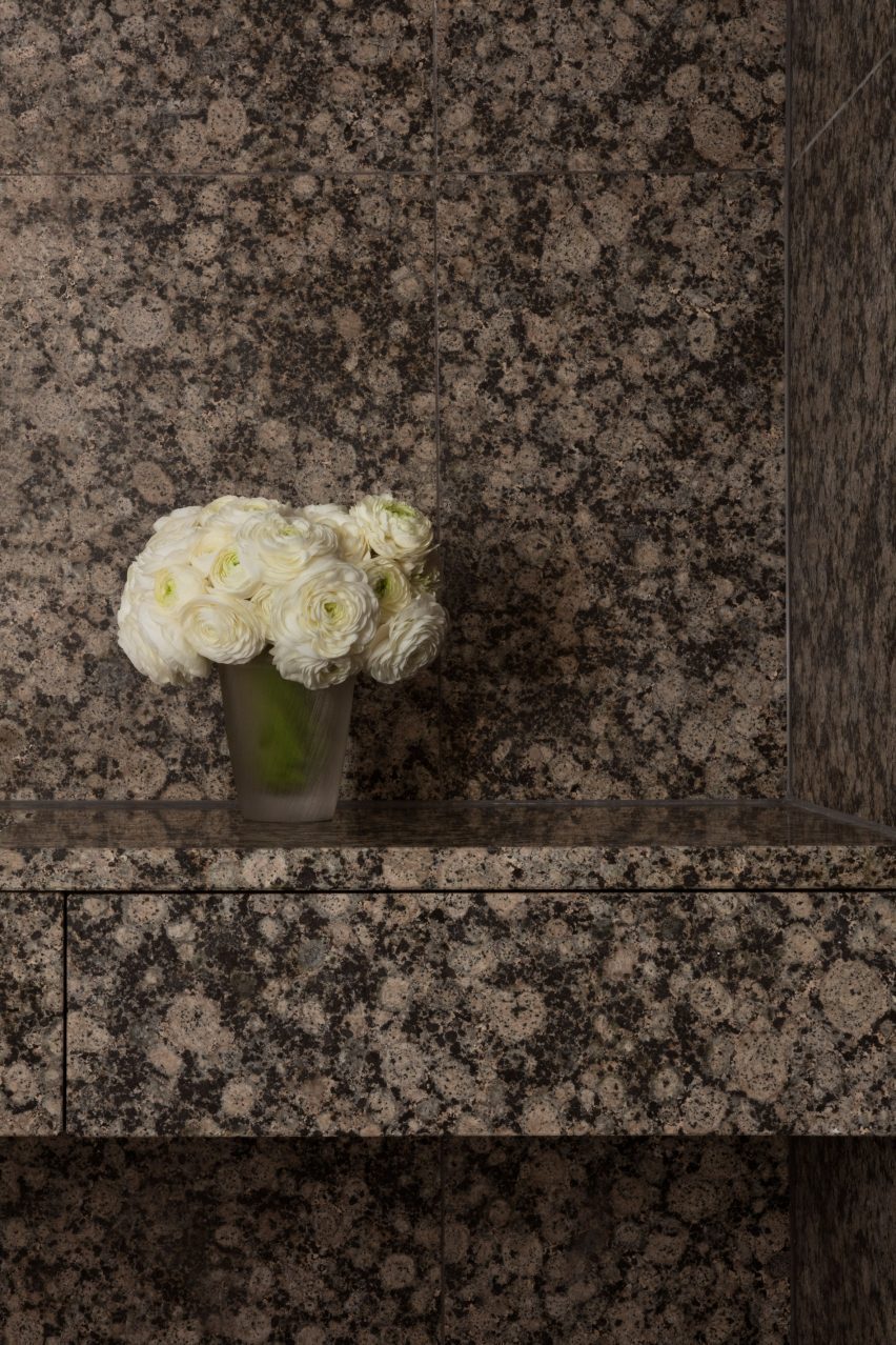 Granite bathroom wall and counter with white flowers