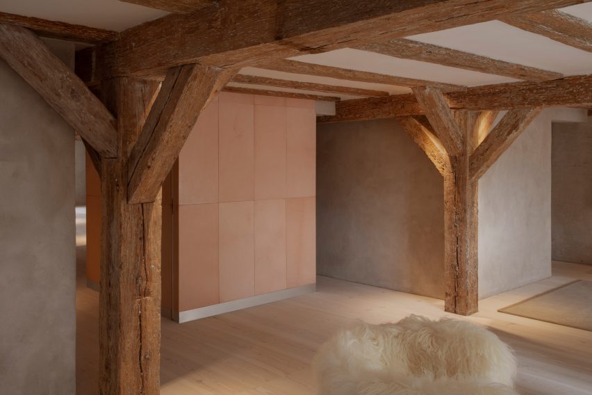 Structural beams and white fluffy chair