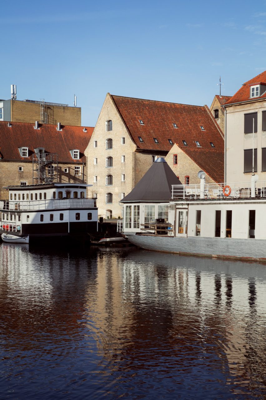 Boats outside canal-side warehouse converted into flats Denmark