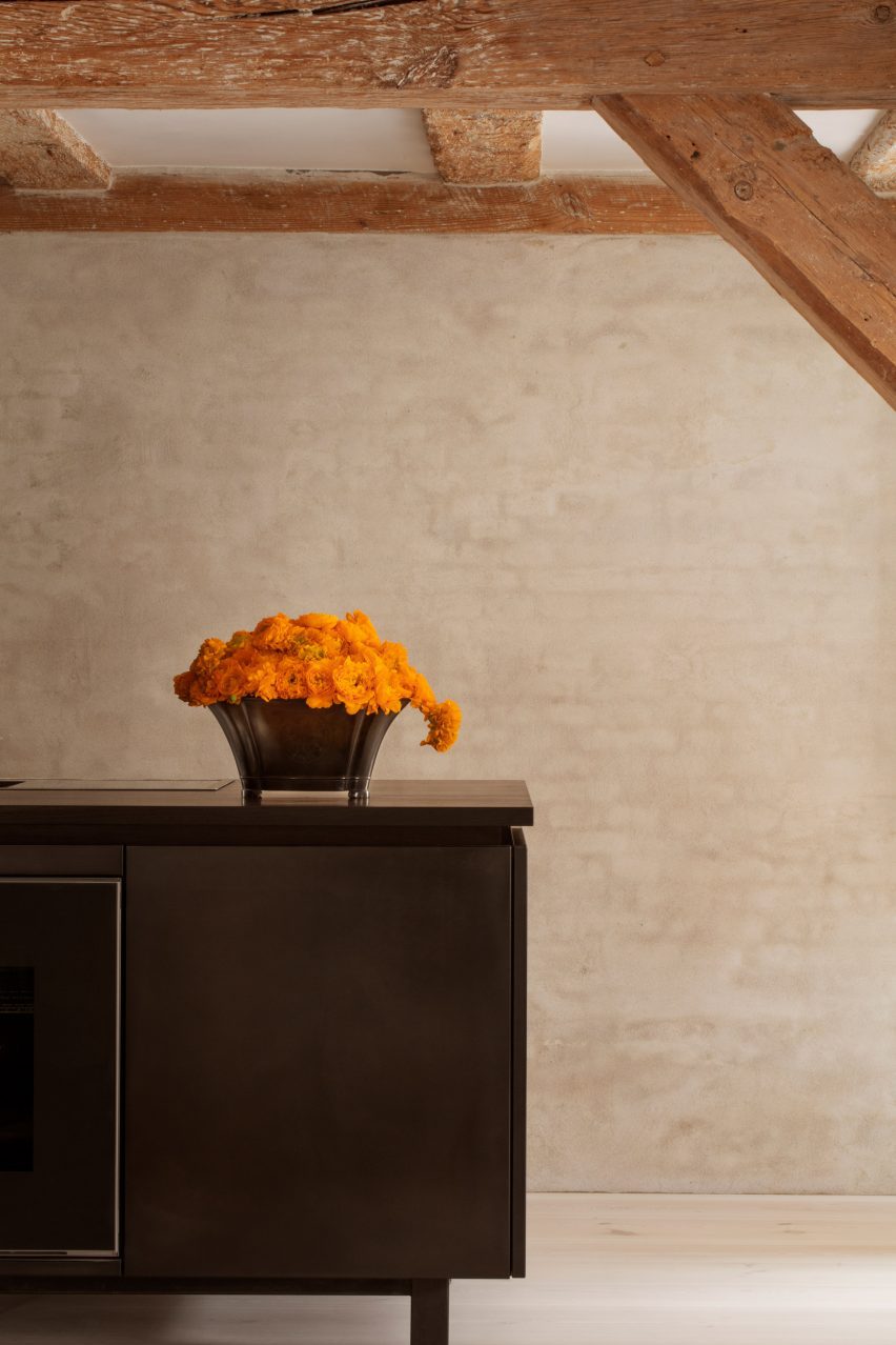 Black kitchen island and orange flowers