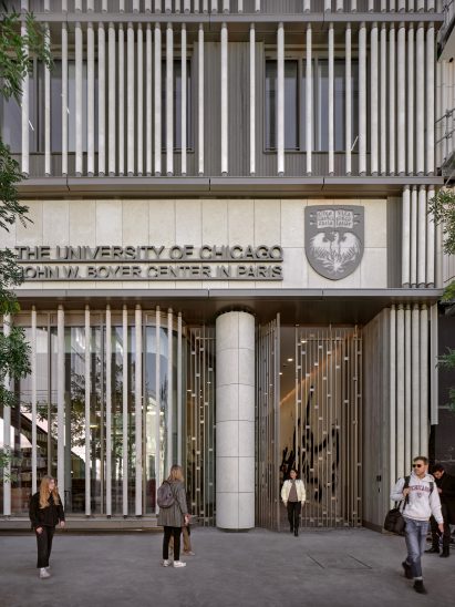 Stone batons on U Chicago research structure in Paris with students outside