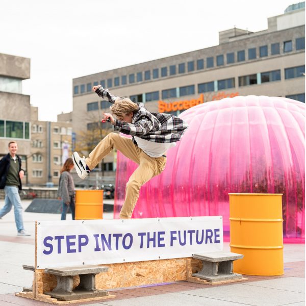 Photo of a person jumping over a sign
