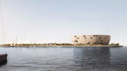 A photograph of a circular structure built atop a body of water.