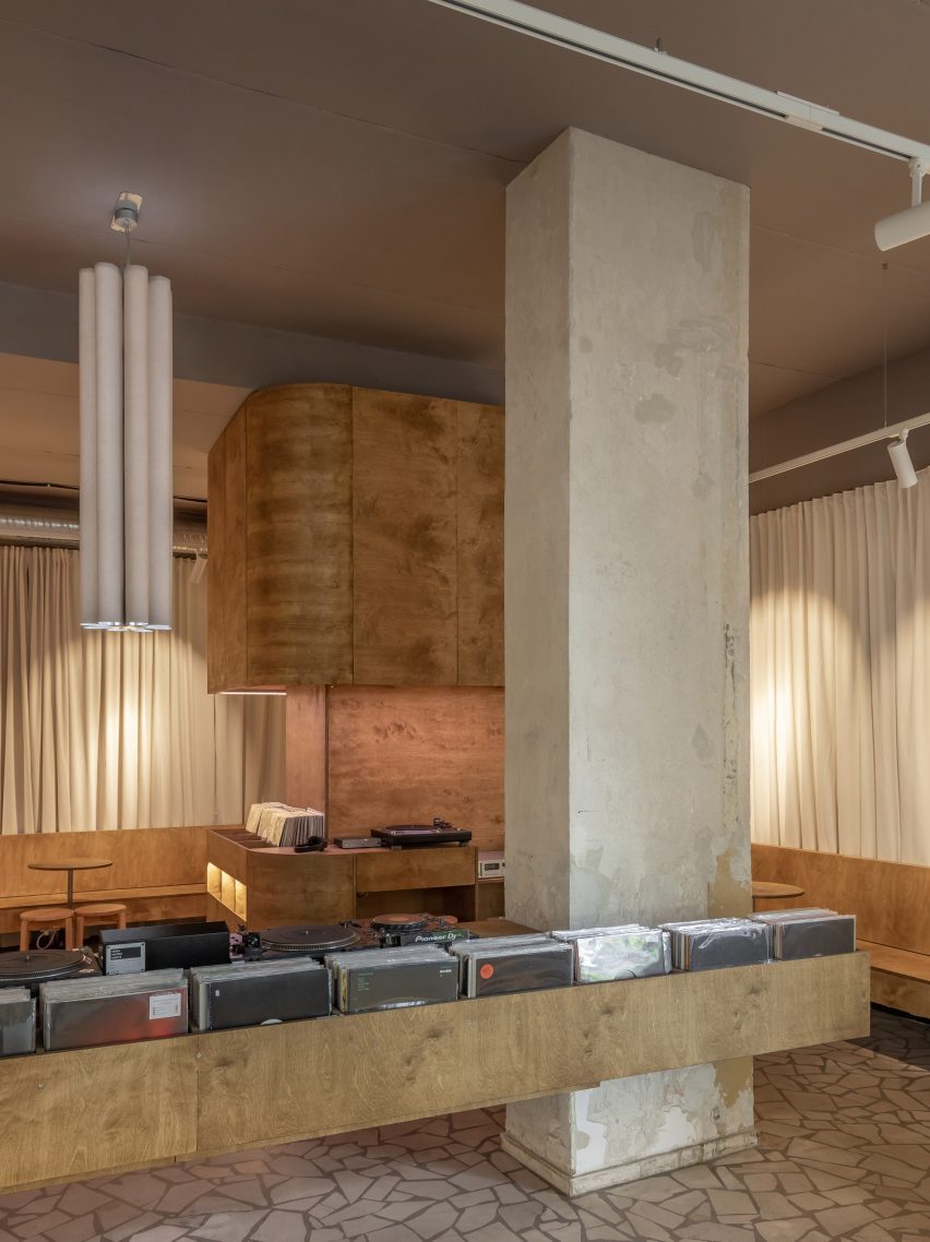 Structural concrete pillars and wooden shelf containing vinyl records