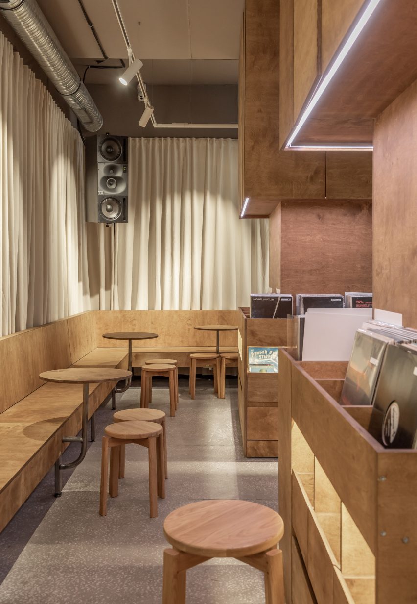 Banquette bench seating and birch plywood wrapped columns containing records