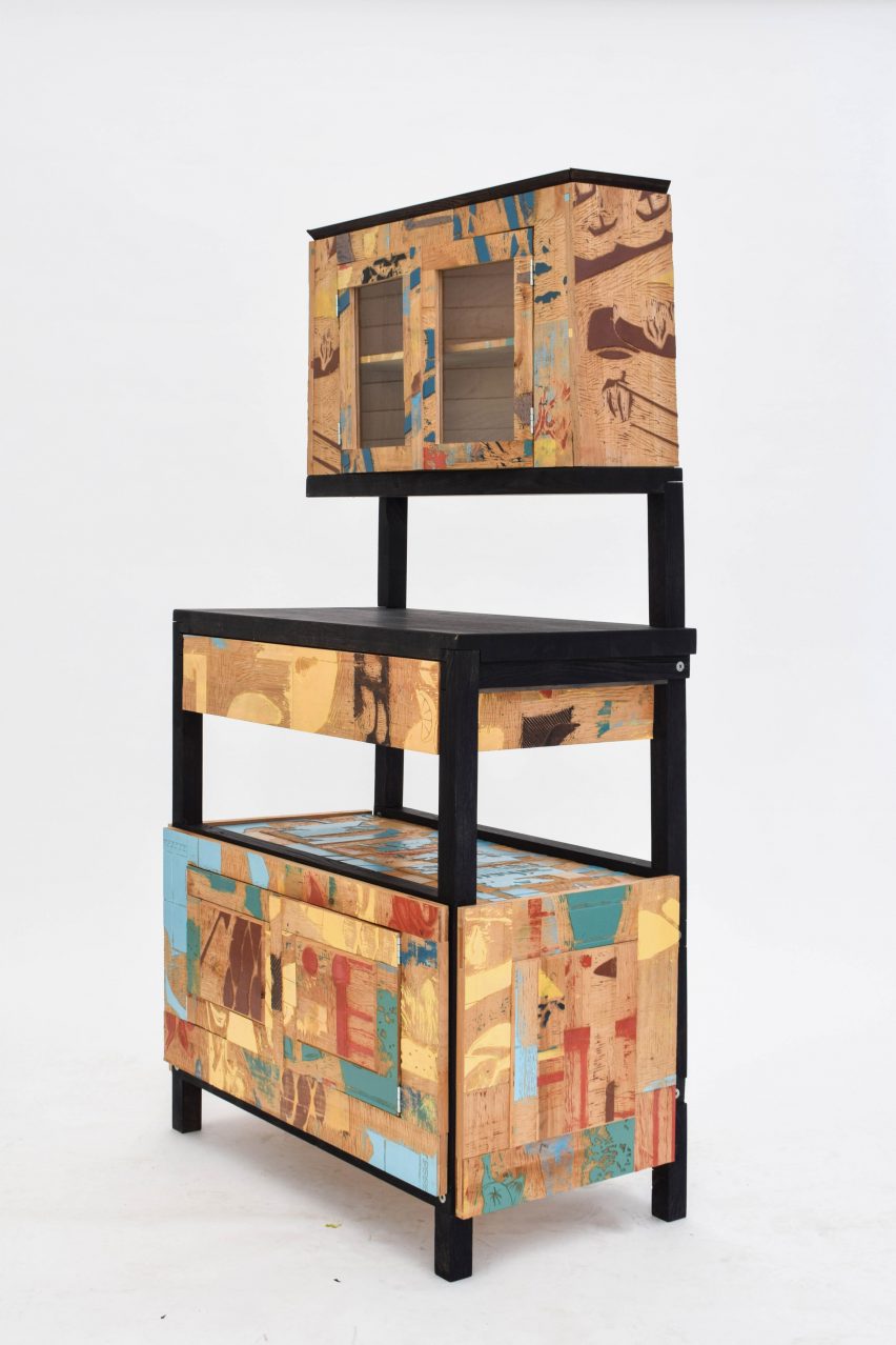 A photograph of a wooden desk with three levels, in tones of brown, blue, yellow, red and green.