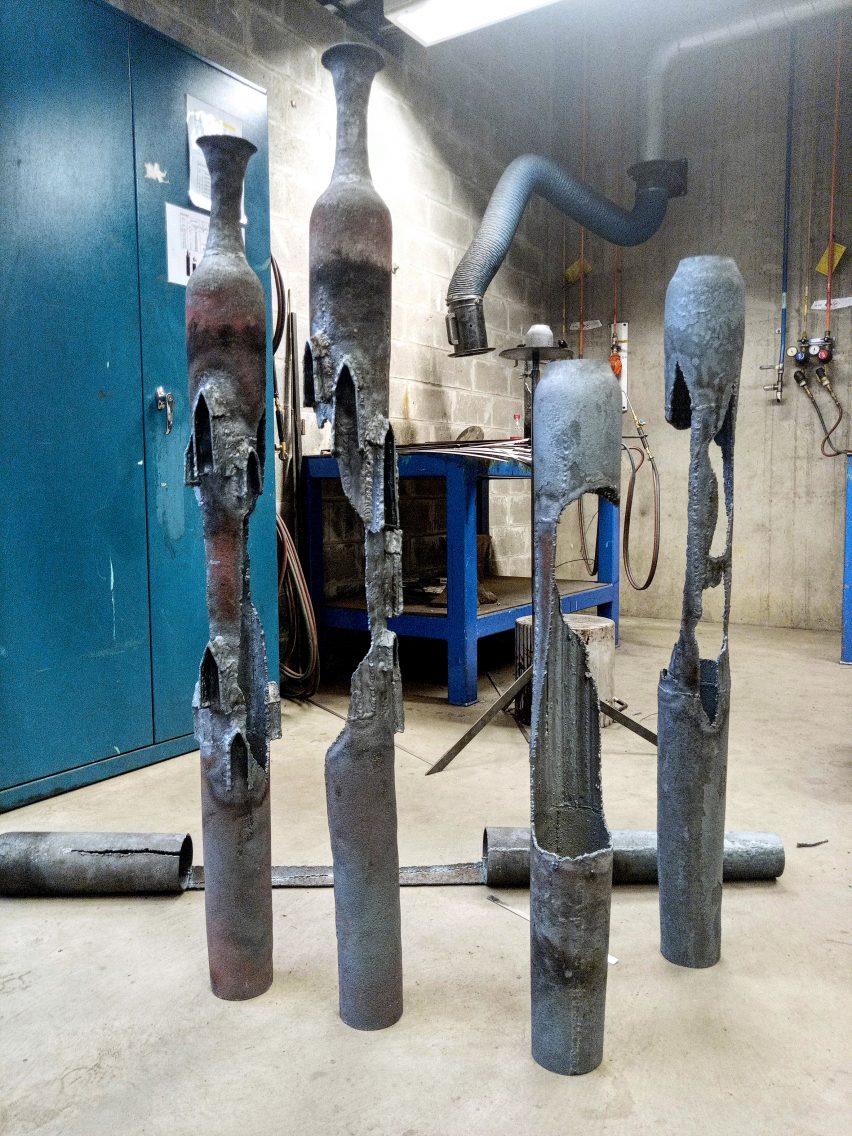 A photograph of four cylindrical metal structures.