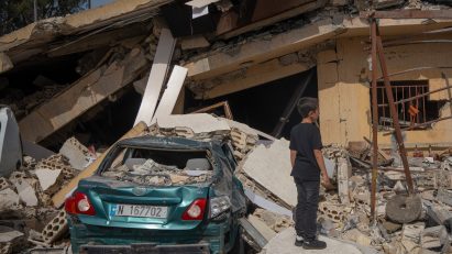 A boy looking at a house damaged in an Israeli strike in Hanine, southern Lebanon