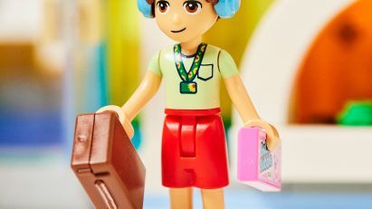 Lego character wearing sunflower lanyard