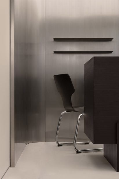 Metallic surfaces and black chair in Inside shop