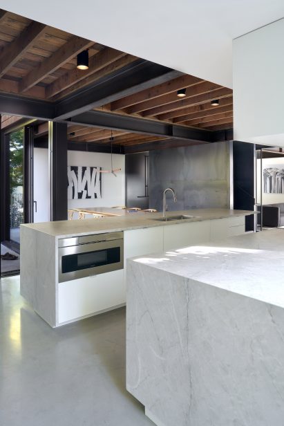 Modern white kitchen with wooden rafters