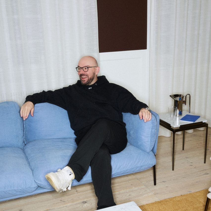 Luca Nichetto sat on blue sofa