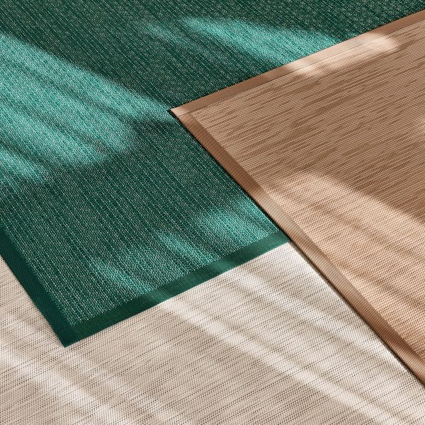 Green, brown and beige rugs on floor