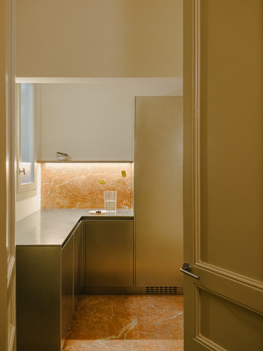 Kitchen with steel cabinets and red marble floors
