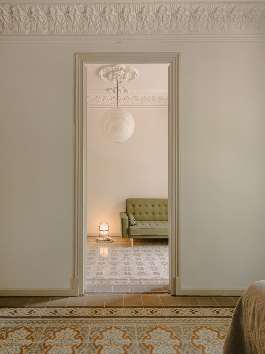 Doorway opening onto room with green sofa