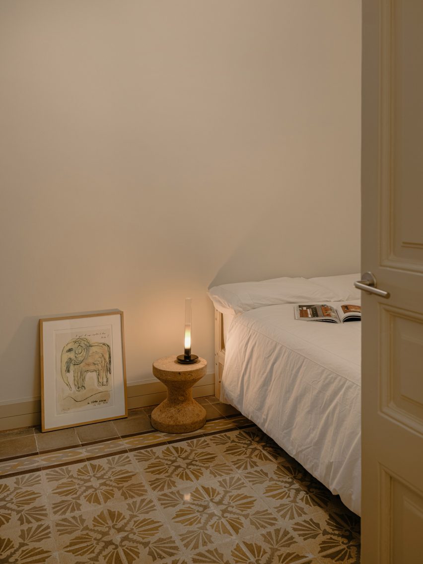 Bed next to side table and lamp in apartment