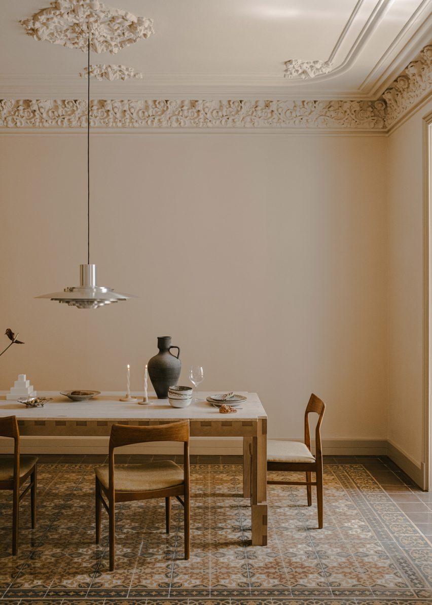 Intricate mosaic floor tiles and decorative ceiling mouldings were carefully restored throughout the apartment