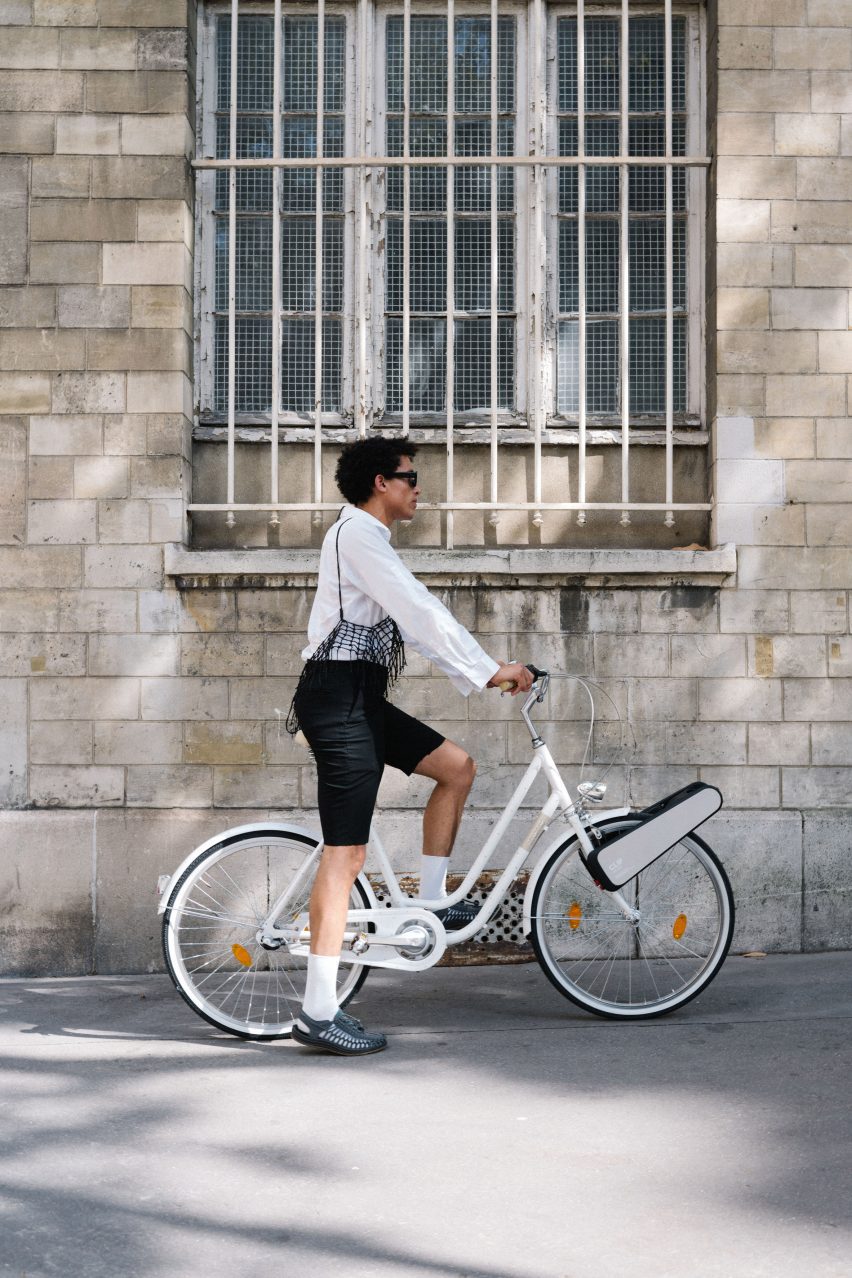 Person stopped on bike with CLIP attachment