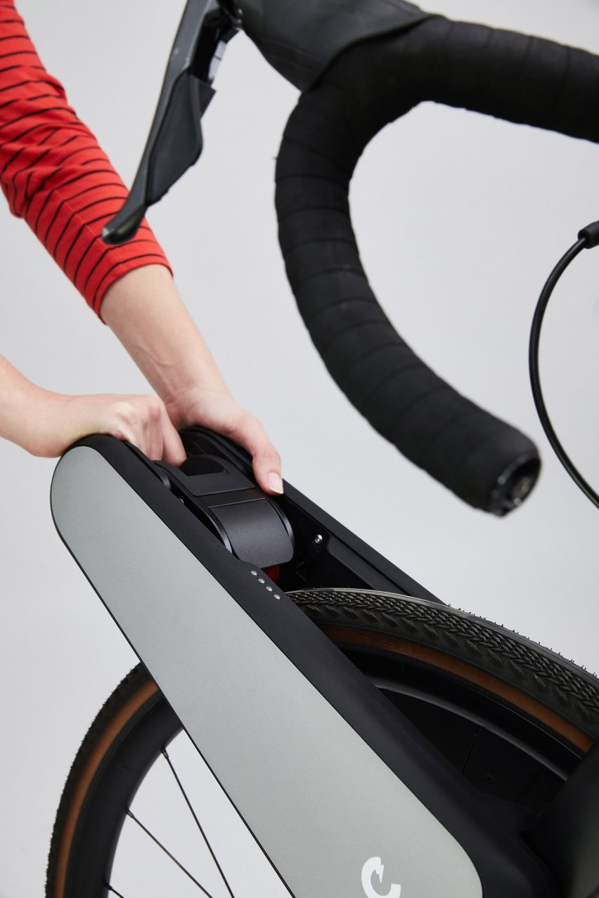 Person pulling lever on e-bike conversion attachment
