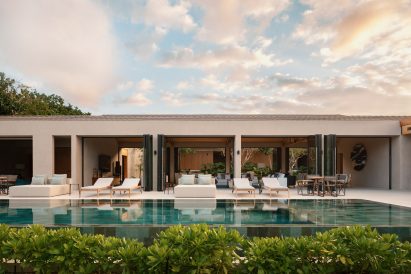 Stone rectilinear house next to a swimming pool