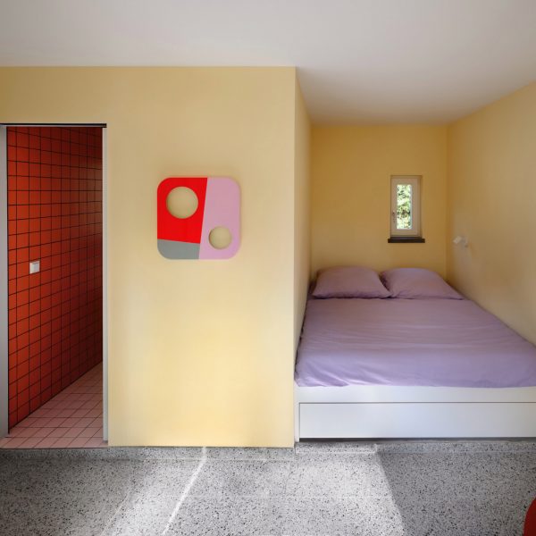 Pale-yellow bedroom in German holiday home