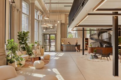 JLL offices interior featuring beige and cream furnishings and plants