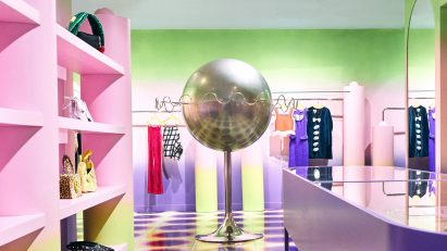 Pink and green interior of Uchronia store with silver planet