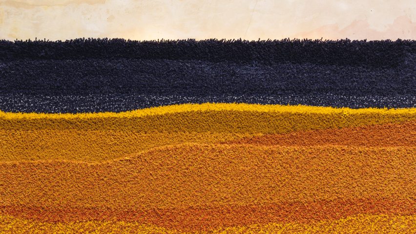 A close up image of an artwork in tones of orange, yellow and black.