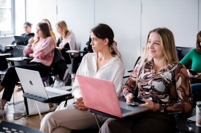 Students with their laptops open attending a lecture