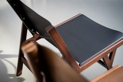 Close up photo of the Biota chair showing the leather-like backrest is attached with screws along one side