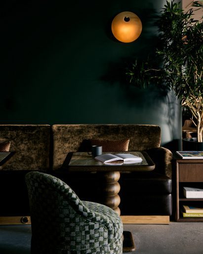 Textured banquette seat against a dark green wall