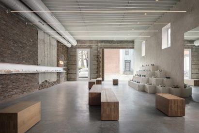 Minimalist shoe shop with expose brick, concrete and plaster walls