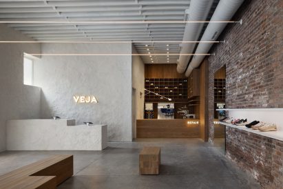 View of a lime plaster sales counter and a white oak-clad repair shop