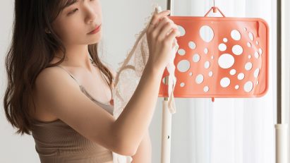 Joyce Lai standing next to her Bras Up hanger
